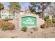 Community sign with stone base surrounded by well-maintained landscaping at 4877 S Torrey Pines Dr # 202, Las Vegas, NV 89103