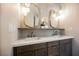 Elegant bathroom with double sinks, marble countertops, and modern lighting fixtures at 501 Proud Eagle Ln, Las Vegas, NV 89144