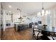 Open-concept kitchen and dining area with an island, modern lighting, and view of a fireplace at 501 Proud Eagle Ln, Las Vegas, NV 89144