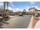 Gated community entrance with lush landscaping, community information board, and desert foliage at 5855 Valley Dr # 2170, North Las Vegas, NV 89031