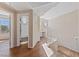 Bright hallway with wood floors, a staircase and a view into the bathroom with shower-tub combo at 5855 Valley Dr # 2170, North Las Vegas, NV 89031