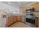 A well-equipped kitchen with modern stainless steel appliances and a view to the living area at 5855 Valley Dr # 2170, North Las Vegas, NV 89031