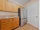 A well-appointed kitchen featuring a stainless steel refrigerator and ample wood cabinetry at 5855 Valley Dr # 2170, North Las Vegas, NV 89031