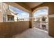 Private covered patio with stucco columns and views of nearby buildings at 5855 Valley Dr # 2170, North Las Vegas, NV 89031