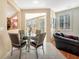 Cozy dining area features tile floors, a round glass table, and plantation shutters for ample natural light at 5873 Wildhorse Ledge Ave, Las Vegas, NV 89131