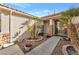 Home entrance with decorative glass doors, desert landscaping, and stone accents adding curb appeal at 5873 Wildhorse Ledge Ave, Las Vegas, NV 89131