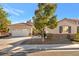 Charming single-story home with a well-manicured lawn, two-car garage, and desert landscaping at 5873 Wildhorse Ledge Ave, Las Vegas, NV 89131