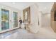 Inviting foyer with decorative mirror, tiled floor and double glass doors creating a warm welcome at 5873 Wildhorse Ledge Ave, Las Vegas, NV 89131