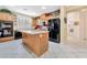 Well-equipped kitchen with an island, black appliances, and ample cabinet space at 5873 Wildhorse Ledge Ave, Las Vegas, NV 89131