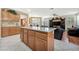 Kitchen island with bar seating and seamless flow into the living room at 5873 Wildhorse Ledge Ave, Las Vegas, NV 89131