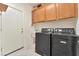 Laundry room with gray washer and dryer, white cabinets, and tiled floors at 5873 Wildhorse Ledge Ave, Las Vegas, NV 89131