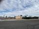 Street-level view of the house showcasing its exterior, surrounding fence, and neighborhood setting at 609 Kasper Ave, Las Vegas, NV 89106