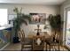 Well-lit dining area featuring modern table, comfortable seating, and an artistic wall decoration at 6103 Harvest Dance St, North Las Vegas, NV 89031