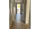 Tiled hallway leading to the front door, bright with natural light and neutral wall colors at 6103 Harvest Dance St, North Las Vegas, NV 89031