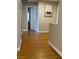 Bright hallway with wood floors leading to various rooms, showcasing natural light and clean lines at 6103 Harvest Dance St, North Las Vegas, NV 89031