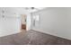 Bright bedroom with plush carpeting, a ceiling fan, and plenty of natural light. The bathroom is adjacent to the bedroom at 6430 Jackrabbit Run Ave, Las Vegas, NV 89122