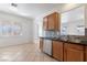 Bright kitchen with tile floors, stainless steel dishwasher, and dark countertops at 6430 Jackrabbit Run Ave, Las Vegas, NV 89122