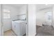 Bright laundry area with tile floors, a window with shutters, washer, and dryer, and is located near the upstairs bedrooms at 6430 Jackrabbit Run Ave, Las Vegas, NV 89122