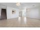 Open floor plan with tile flooring, staircase, and bright white walls at 6430 Jackrabbit Run Ave, Las Vegas, NV 89122