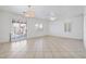 Large living room featuring tile floors, neutral walls, and modern ceiling fans at 6430 Jackrabbit Run Ave, Las Vegas, NV 89122