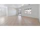 Bright living room featuring tile floors, plantation shutters, and neutral paint at 6430 Jackrabbit Run Ave, Las Vegas, NV 89122