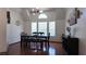 Formal dining room with hardwood floors, lots of natural light and black table with seating for six at 6545 Bradford Ln, Las Vegas, NV 89108