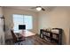 Functional home office with a desk, computer setup, shelving unit, and natural light at 6545 Bradford Ln, Las Vegas, NV 89108