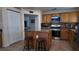 Functional kitchen featuring wooden cabinets, stainless appliances, granite countertops, and a central island at 6545 Bradford Ln, Las Vegas, NV 89108