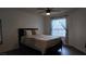 Serene main bedroom with a plush bed, natural light, and dark wood floors at 6545 Bradford Ln, Las Vegas, NV 89108