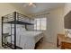 Neutral bedroom featuring a bunk bed and wooden desk at 6917 Leon Ave, Las Vegas, NV 89131