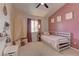 A bedroom with light pink accents, a book shelf, and a canopy bed at 6917 Leon Ave, Las Vegas, NV 89131