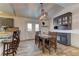 Bright dining area with a wooden table, chairs and a modern light fixture at 6917 Leon Ave, Las Vegas, NV 89131