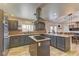 Bright kitchen with central island, stainless steel appliances, and wooden cabinets at 6917 Leon Ave, Las Vegas, NV 89131