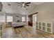 Comfortable main bedroom with wood floors, a sliding barn door, and a ceiling fan at 6917 Leon Ave, Las Vegas, NV 89131