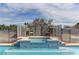 Swimming pool with a waterfall feature and chairs at 6917 Leon Ave, Las Vegas, NV 89131