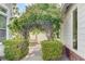 Backyard featuring a brick path with an arbor, a wooden swing, and mature landscaping at 7220 Shenandoah Springs Ave, Las Vegas, NV 89131