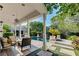 A covered patio features outdoor seating with views of a refreshing pool and lush landscaping at 7220 Shenandoah Springs Ave, Las Vegas, NV 89131