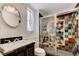 Stylish bathroom with a unique multicolored tiled shower and modern fixtures at 7220 Shenandoah Springs Ave, Las Vegas, NV 89131