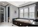 Bright bathroom featuring a soaking tub, vanity, and frosted glass window at 7220 Shenandoah Springs Ave, Las Vegas, NV 89131