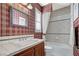 This bathroom offers a shower and tub combo, and is decorated with checkered wallpaper at 7220 Shenandoah Springs Ave, Las Vegas, NV 89131