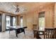 An airy game room with wood ceiling, tile floor, game table, and glass doors to the outdoor pool area at 7220 Shenandoah Springs Ave, Las Vegas, NV 89131