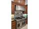 A close up on the kitchen features a stainless steel range with a stainless steel range hood at 7220 Shenandoah Springs Ave, Las Vegas, NV 89131