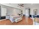 This main bedroom features hardwood floors, a ceiling fan, and a chest at the foot of the bed at 7220 Shenandoah Springs Ave, Las Vegas, NV 89131