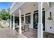 A covered patio with seating offers a view of the well-maintained yard, playhouse, and home's architecture at 7220 Shenandoah Springs Ave, Las Vegas, NV 89131