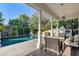 Covered patio with outdoor seating overlooks the pool, a lush garden, and a playhouse at 7220 Shenandoah Springs Ave, Las Vegas, NV 89131