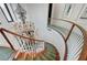 Elevated view of curved staircase featuring a decorative chandelier and black and white tile at 7220 Shenandoah Springs Ave, Las Vegas, NV 89131