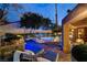 Backyard with built-in spa, outdoor kitchen, and lounge seating at 7607 Boca Raton Dr, Las Vegas, NV 89113