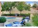 Relaxing backyard spa with lounge chairs and lush landscaping at 7607 Boca Raton Dr, Las Vegas, NV 89113