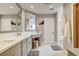 Bright bathroom with double sinks, white countertops, a vanity area, and walk-in shower at 7607 Boca Raton Dr, Las Vegas, NV 89113