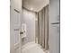 Well-lit bathroom with a shower and gray storage cabinets for organized living at 7607 Boca Raton Dr, Las Vegas, NV 89113